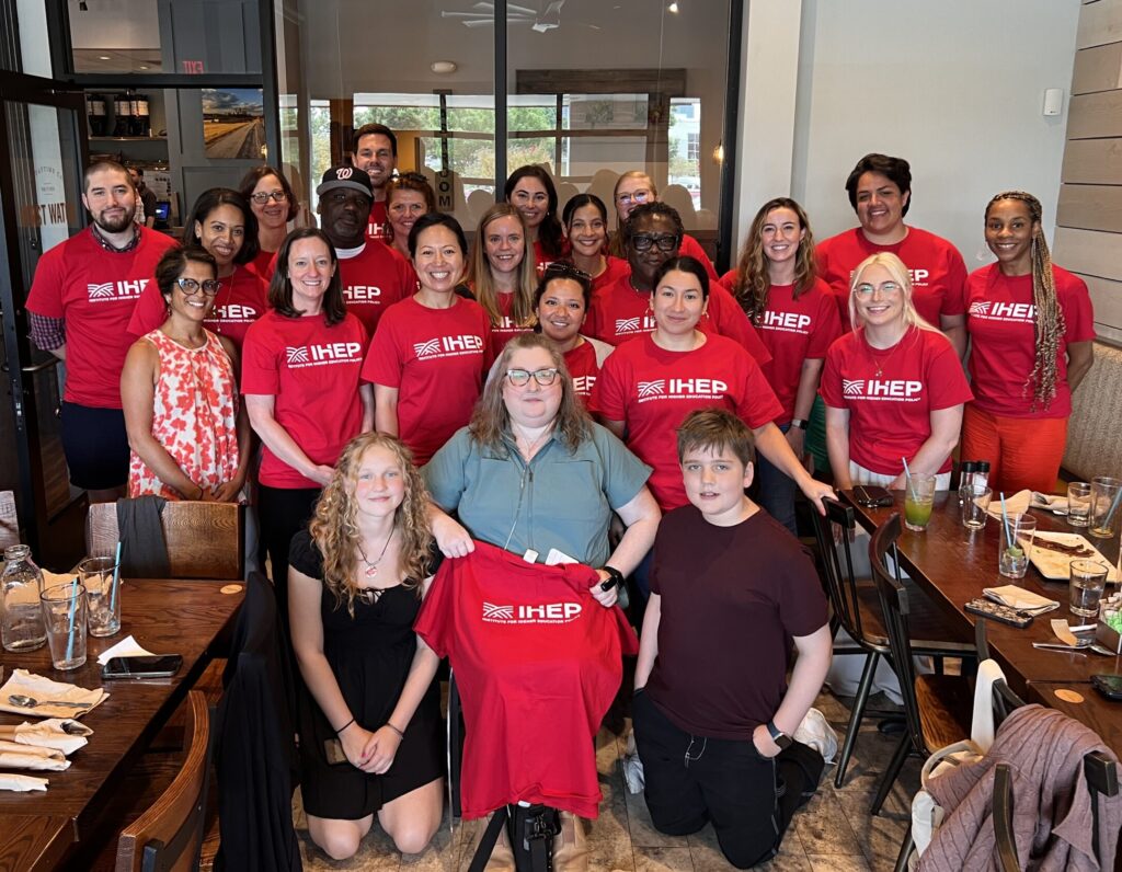 IHEP staff wearing red t shirts gathered at celebration for Lacey Leegwater